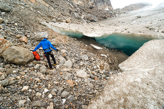 Male guide prepares rappel rope for particpants to explore an ice cave on a trekking adventure on Lemon Glacier, Juneau Icefield, Juneau, Alaska, USA