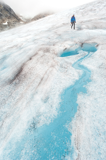 Guide descends an icy slope, Lemon Glacier, Juneau Icefield, Juneau, Alaska, USA