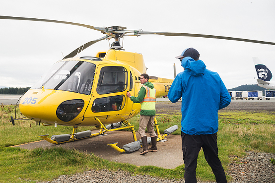 Pilot preparing helicopter for take off, Juneau, Alaska