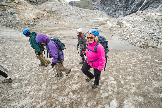 People hike across challenging terrain on a trekking adventure on Lemon Glacier, Juneau Icefield, Juneau, Alaska, USA