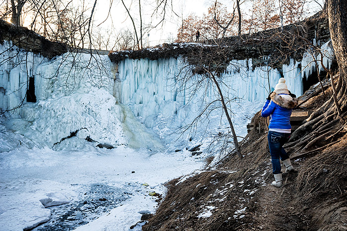 Exploring behind Minnehaha frozen waterfall in Minneapolis, Minnesota, USA