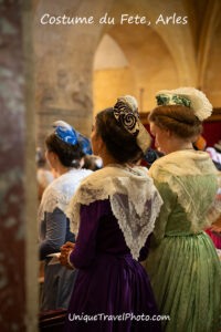 Fete du Costume ceremony in Notre Dame church, where over 500 women dress in traditional attire from their region depicting differing lace and hats in this annual summer festival, Arles, France, Europe